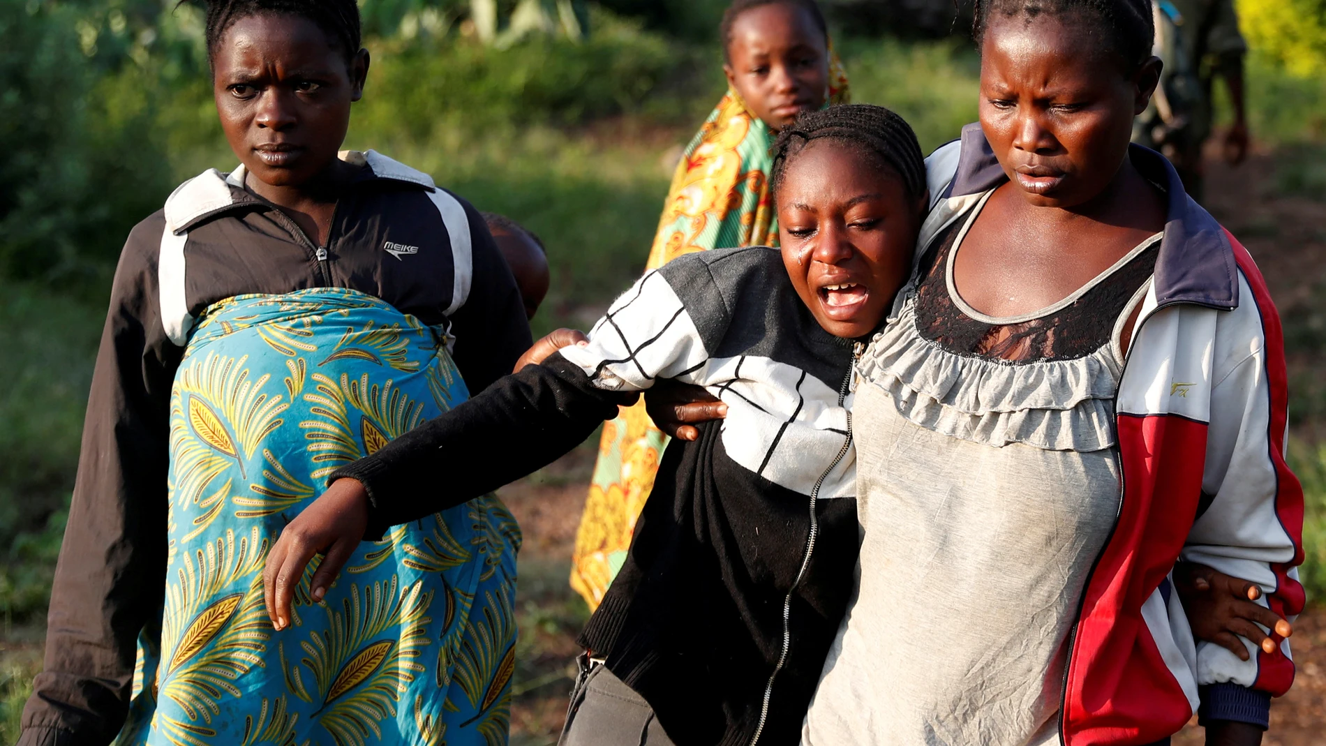 FILE PHOTO: A woman reacts after five other women were killed in Paida, near Beni