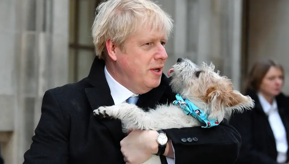 El Primer Ministro británico, Boris Johnson y su perro Dilyn a la salida del colegio electoral.