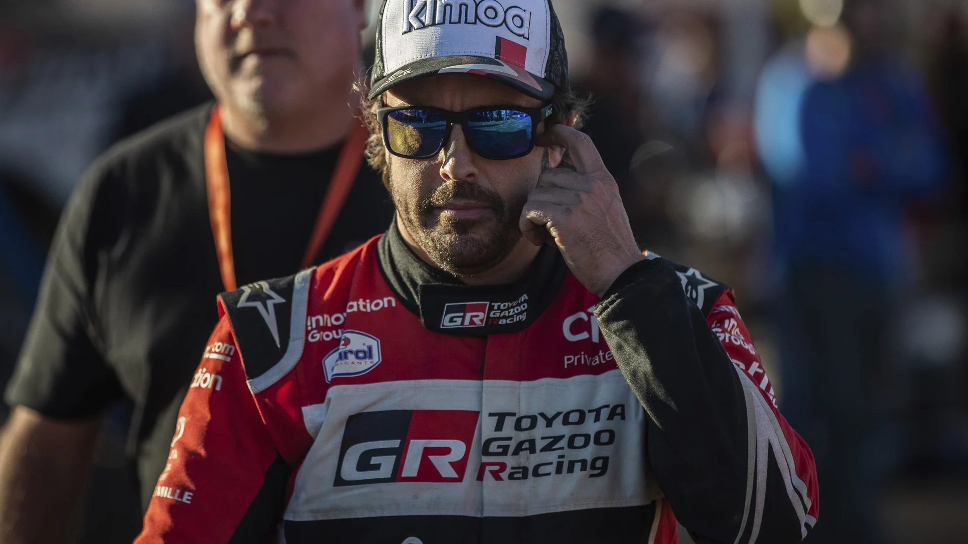 Driver Fernando Alonso, of Spain, walks at the bivouac after stage two of the Dakar Rally in Neom, Saudi Arabia, Monday, Jan. 6, 2020. (AP Photo/Bernat Armangue)