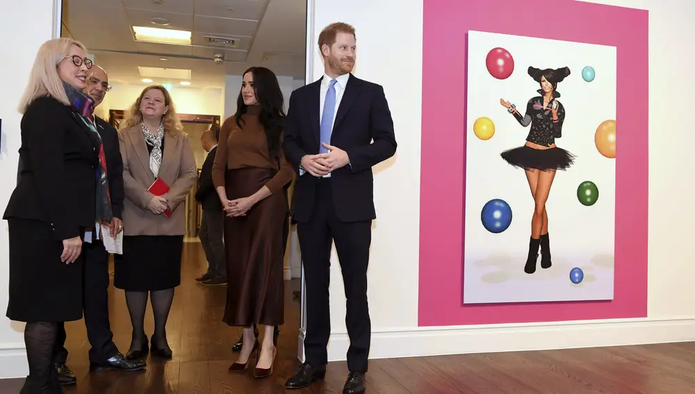 Britain's Prince Harry and Meghan, Duchess of Sussex look at an art exhibition by Indigenous Canadian artist Skawennati in the Canada Gallery, during their visit to Canada House to meet with Canada's High Commissioner to the UK, Janice Charette, as well as staff to thank them for the warm hospitality and support they received during their recent stay in Canada, in London, Tuesday, Jan. 7, 2020. (Daniel Leal-Olivas/Pool Photo via AP)