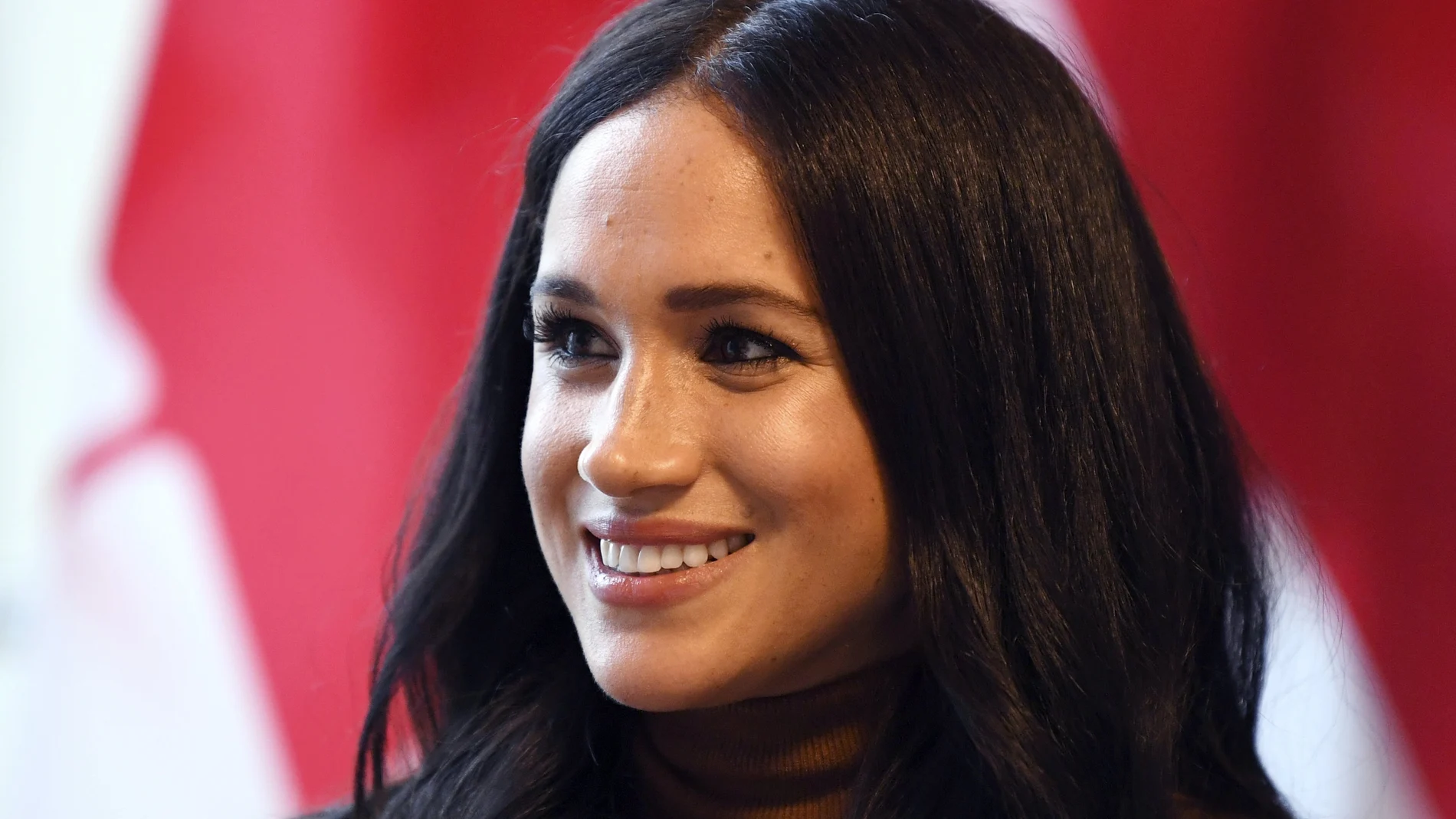 Britain's Meghan, Duchess of Sussex smiles during her visit with Prince Harry to Canada House in thanks for the warm Canadian hospitality and support they received during their recent stay in Canada, in London, Tuesday, Jan. 7, 2020. (Daniel Leal-Olivas/Pool Photo via AP)