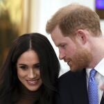 Britain's Prince Harry and Meghan, Duchess of Sussex smile during their visit to Canada House in thanks for the warm Canadian hospitality and support they received during their recent stay in Canada, in London, Tuesday, Jan. 7, 2020. (Daniel Leal-Olivas/Pool Photo via AP)