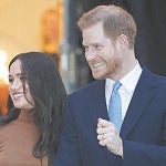 FILE - In this Tuesday Jan. 7, 2020 file photo Britain's Prince Harry and Meghan, Duchess of Sussex leave after visiting Canada House in London after their recent stay in Canada. In a stunning declaration, Britain's Prince Harry and his wife, Meghan, said they are planning "to step back" as senior members of the royal family and "work to become financially independent." A statement issued by the couple Wednesday, Jan. 8, 2020 also said they intend to "balance" their time between the U.K. and North America. (AP Photo/Frank Augstein, FILE)