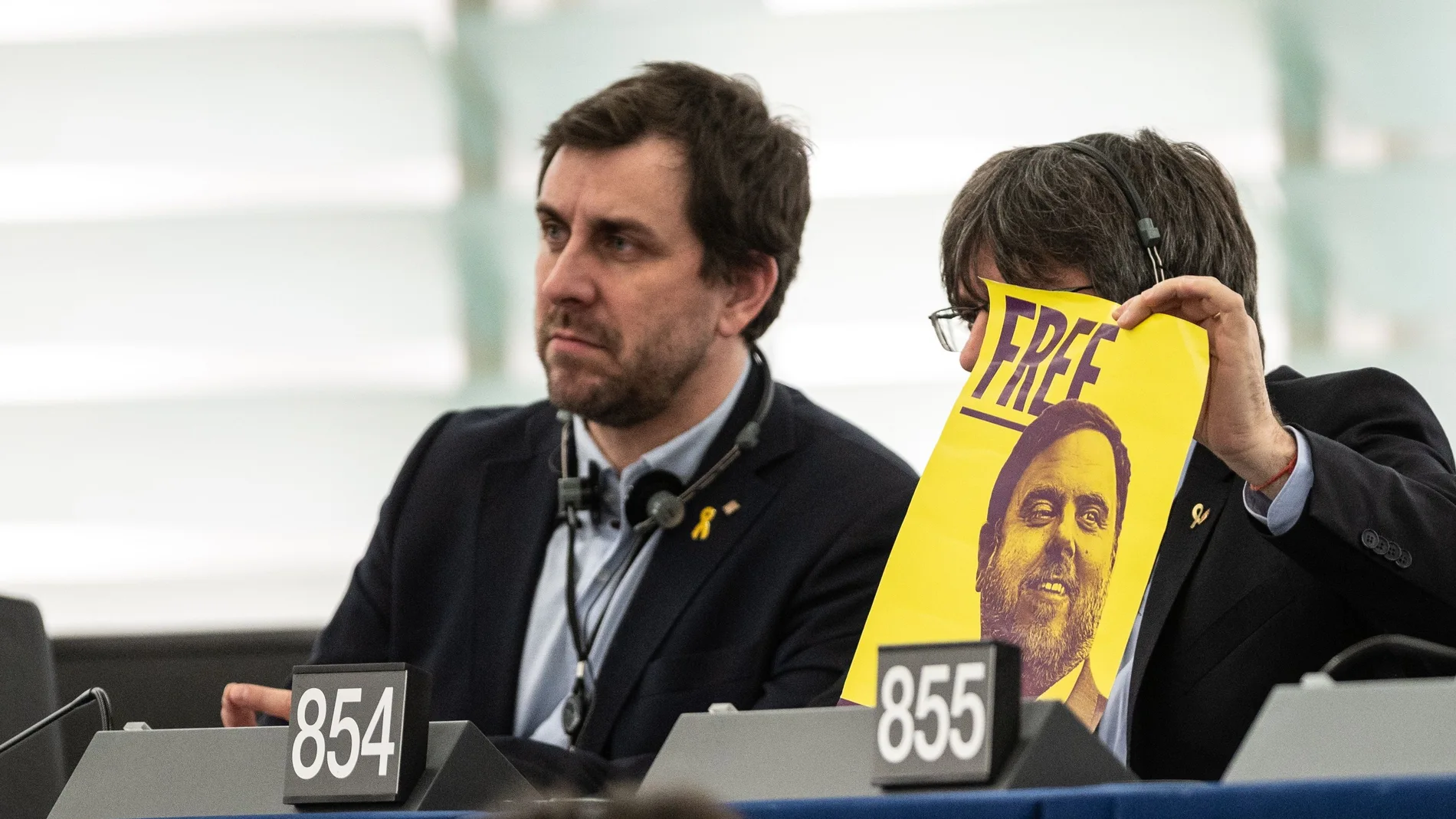 Toni Comin y Carles Puigdemont (R) con un cartel en el que solicitan la libertad de Junqueras