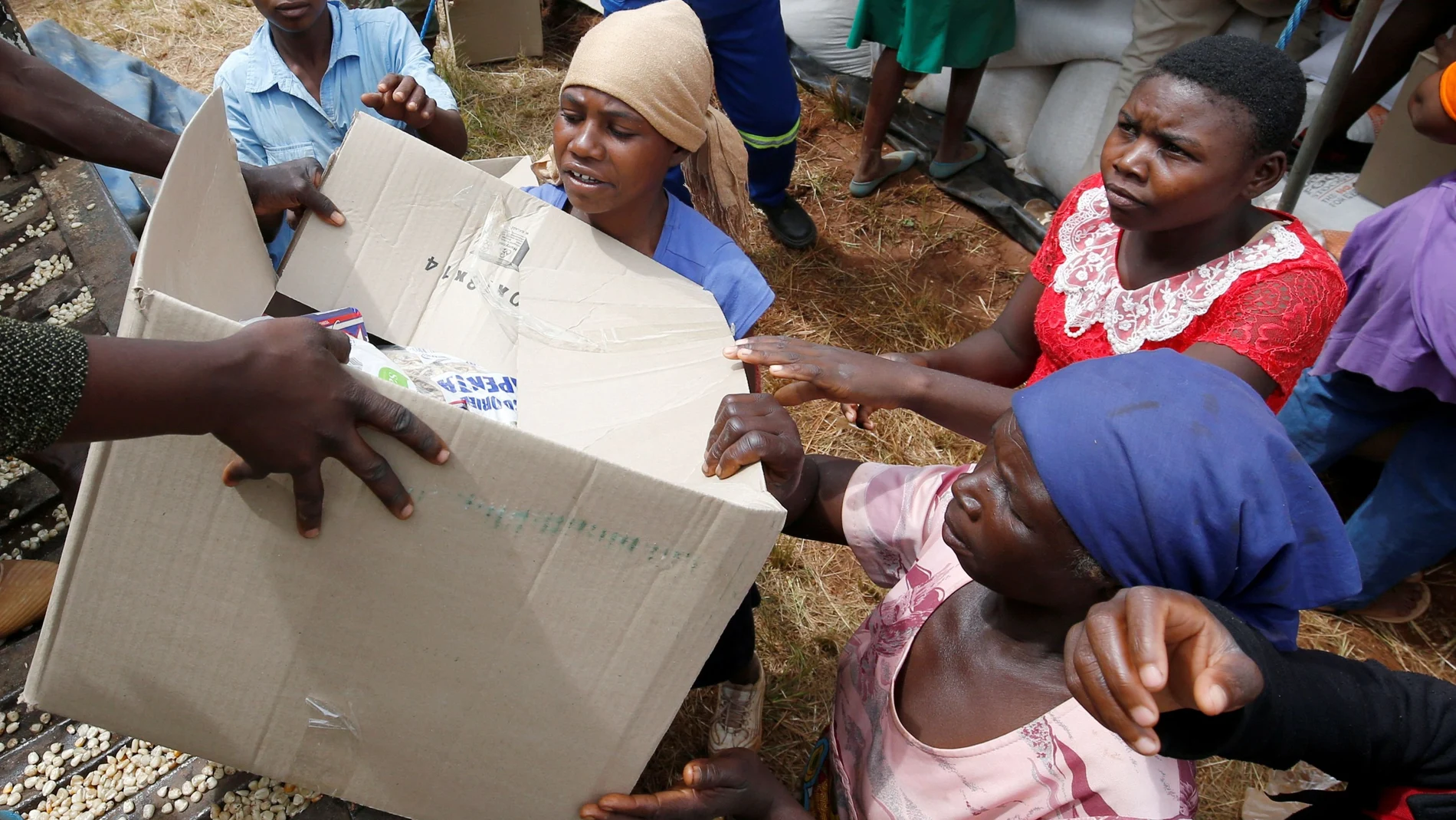 FILE PHOTO: Victims of Cyclone Idai receive food aid at Siverstream Estates in Chipinge
