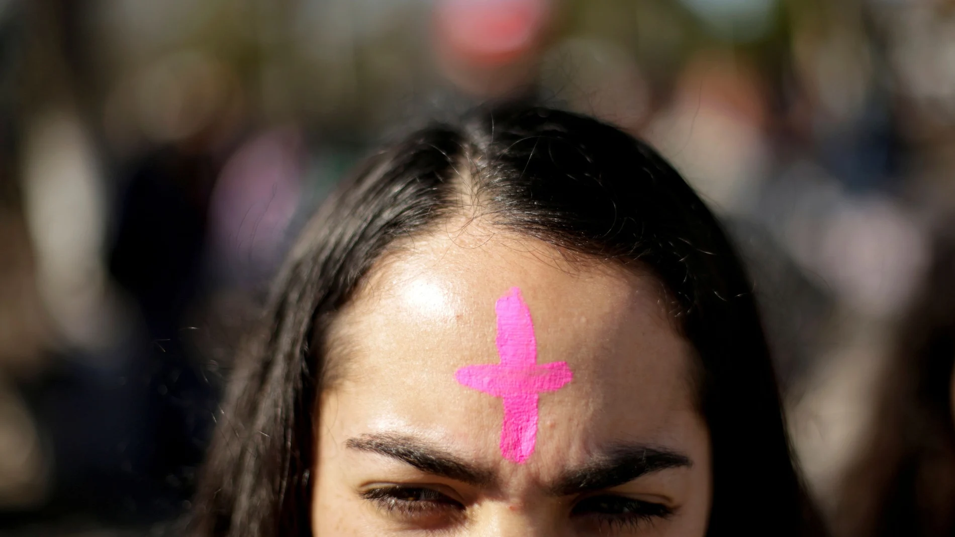 A woman with a pink cross on his forehead takes part in a protest to demand justice for Isabel Cabanillas, an activist for women rights whose body was found last Saturday, in Ciudad Juarez