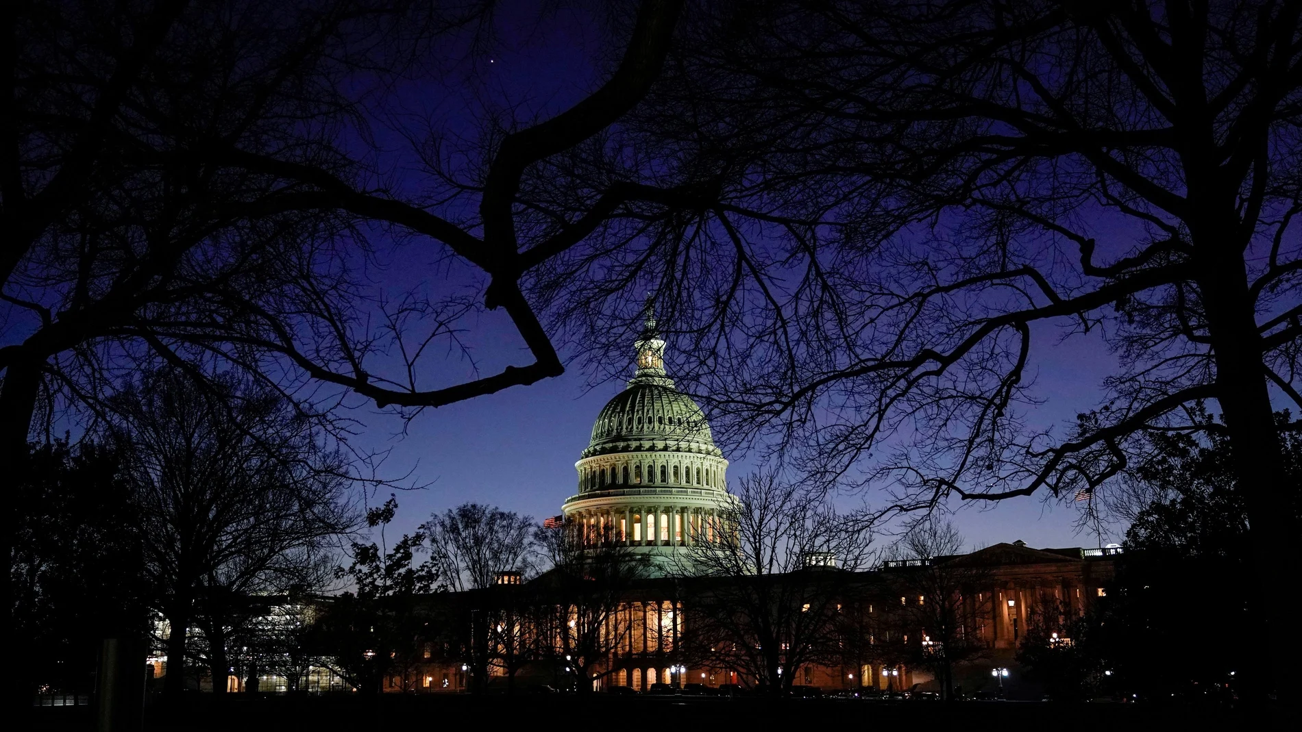 FILE PHOTO: The U.S. Capitol stands as evening falls on the first day of the Trump impeachment trial in Washington.