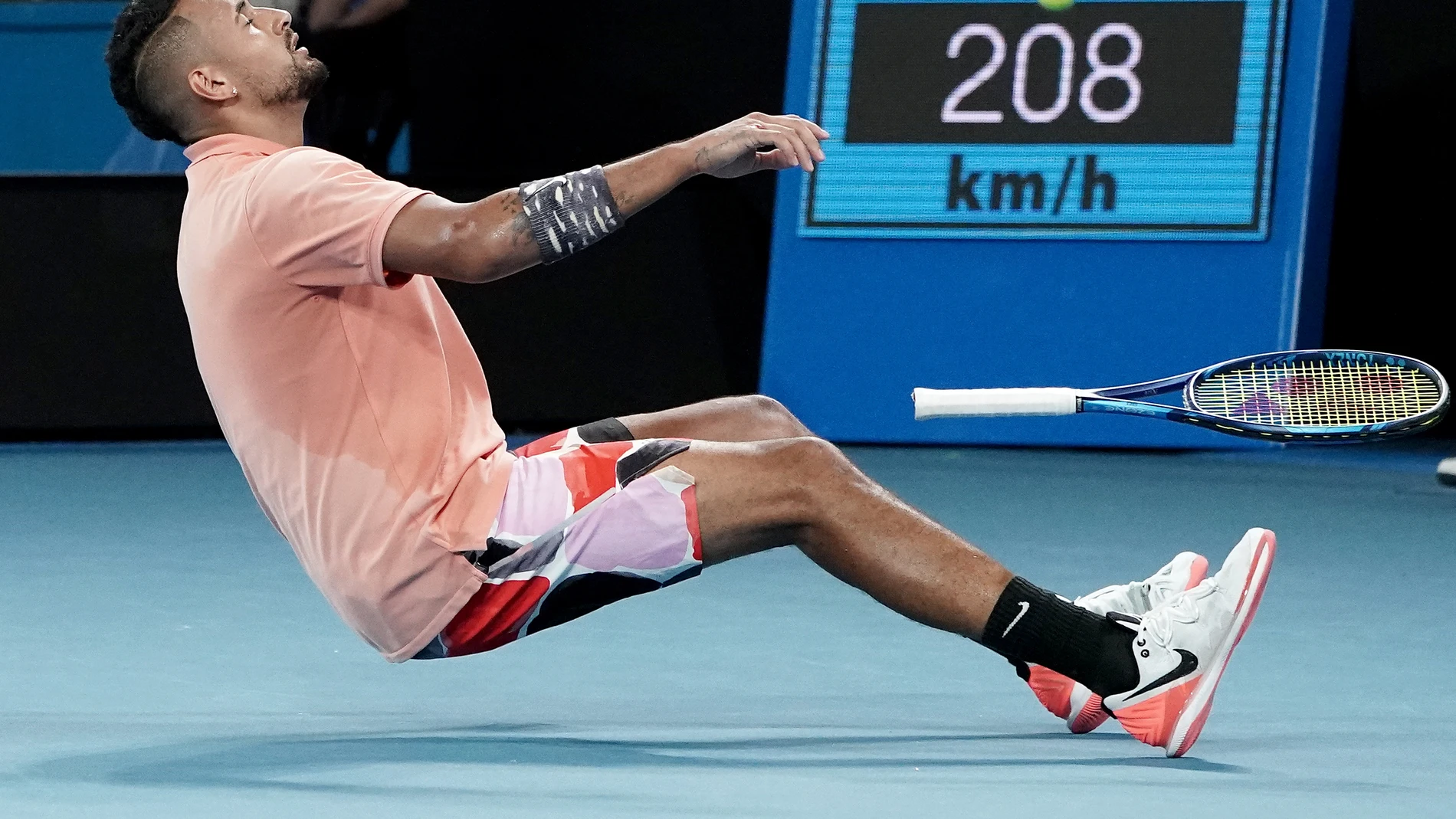 Nick Kyrgios of Australia falls to the ground as he celebrates winning his third round match against Karen Kachanov of Russia on day six of the Australian Open tennis tournament at Melbourne Arena in Melbourne, Saturday, January 25, 2020. (AAP Image/Dave