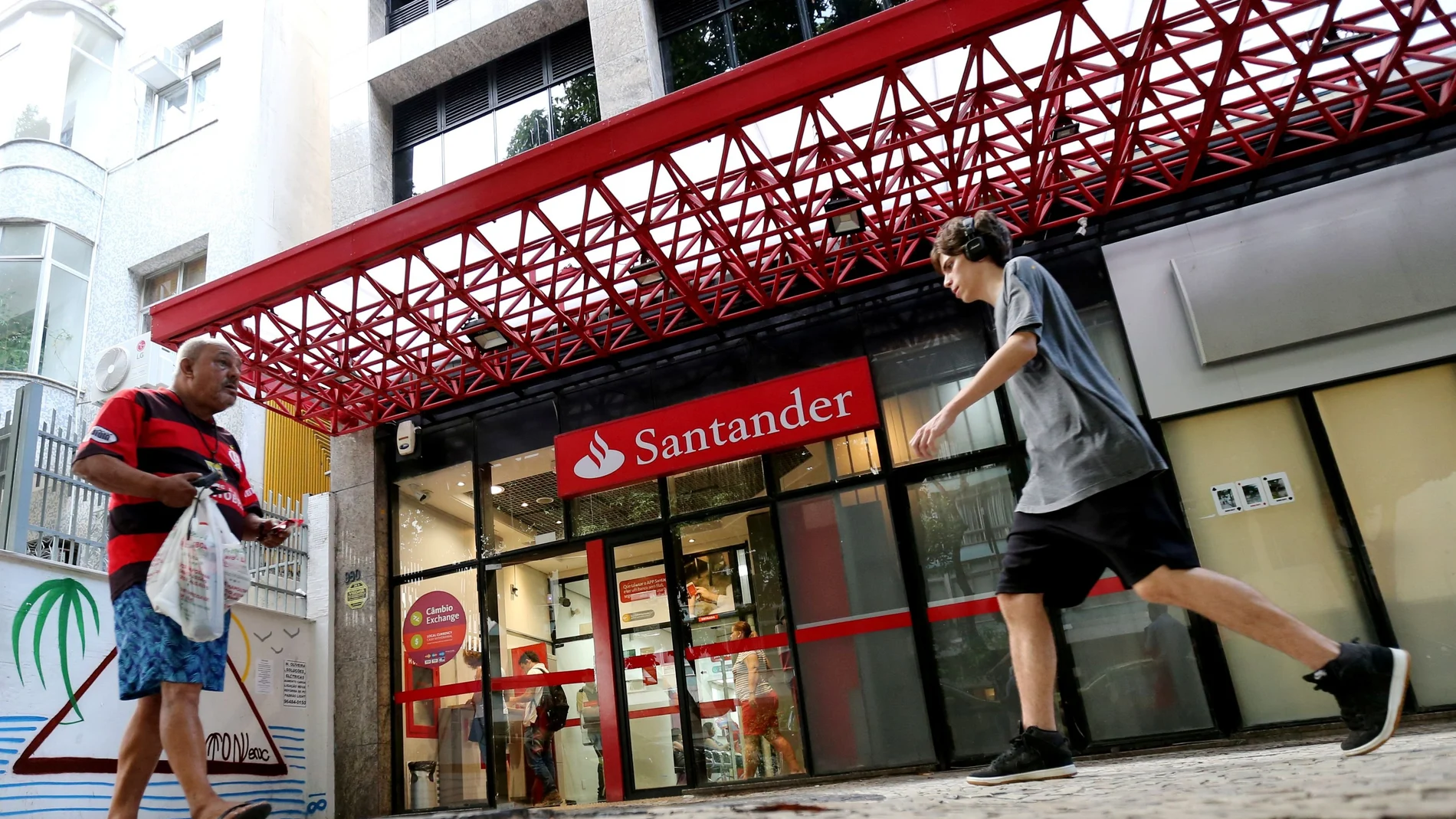FILE PHOTO: People walk past a Banco Santander branch in Rio de Janeiro