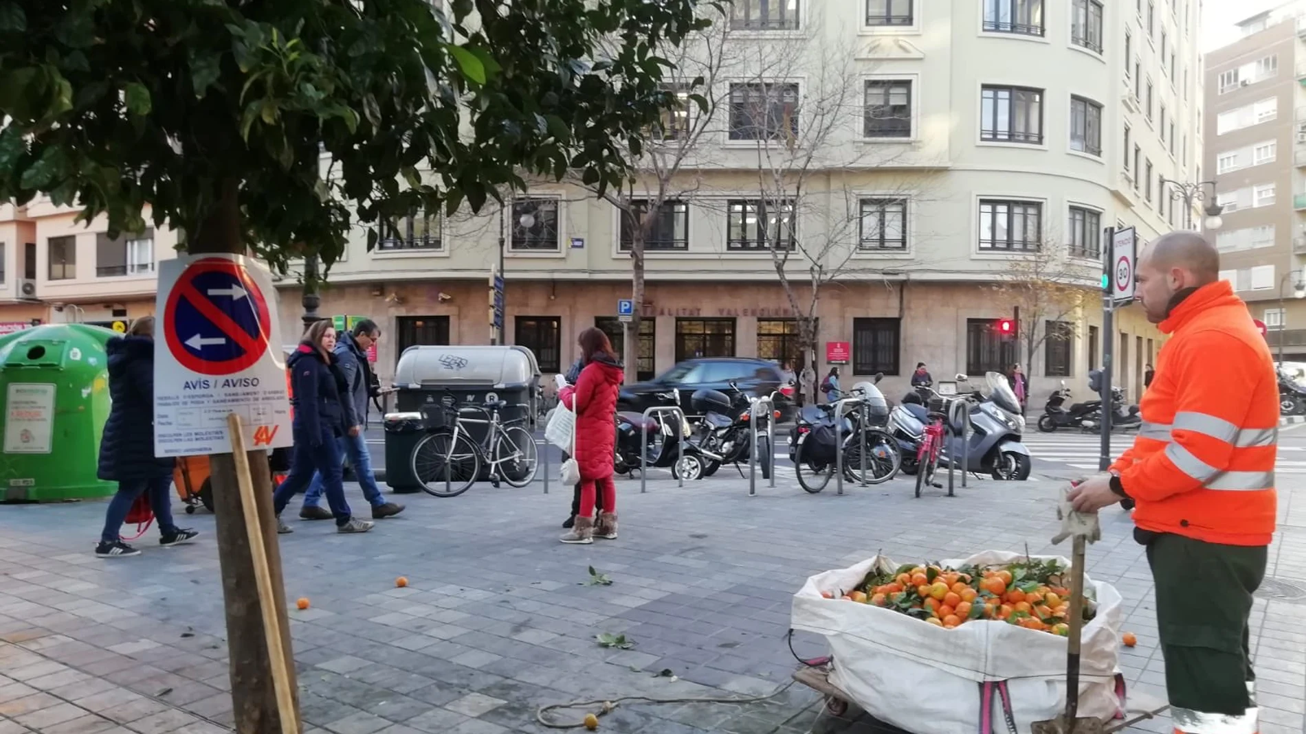 Unos operarios retiran las naranjas de las calles