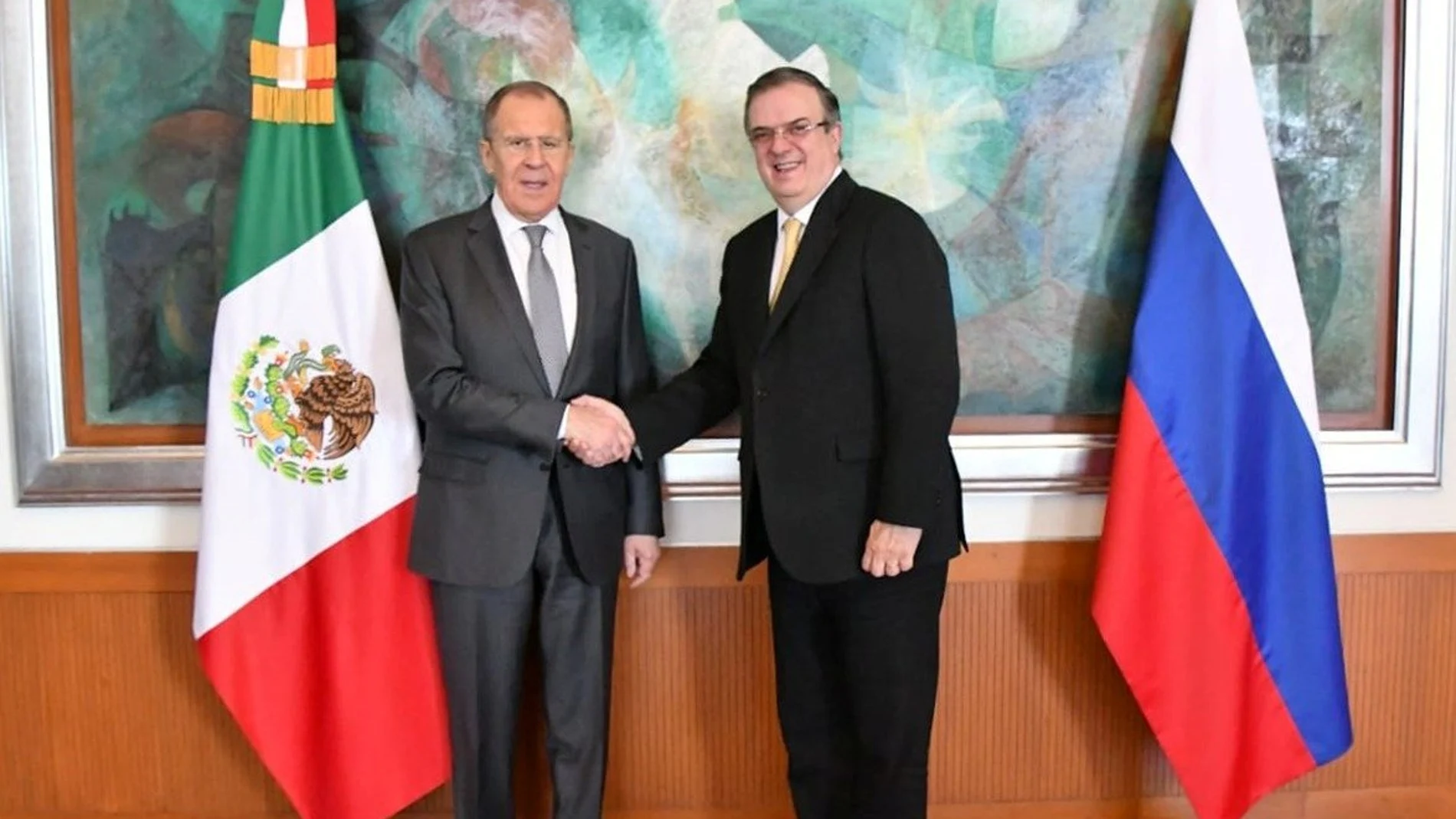 Russian Foreign Minister Sergei Lavrov shakes hands with Mexico's Foreign Minister Marcelo Ebrard after a private meeting at the Foreign Ministry Building (SRE) in Mexico City