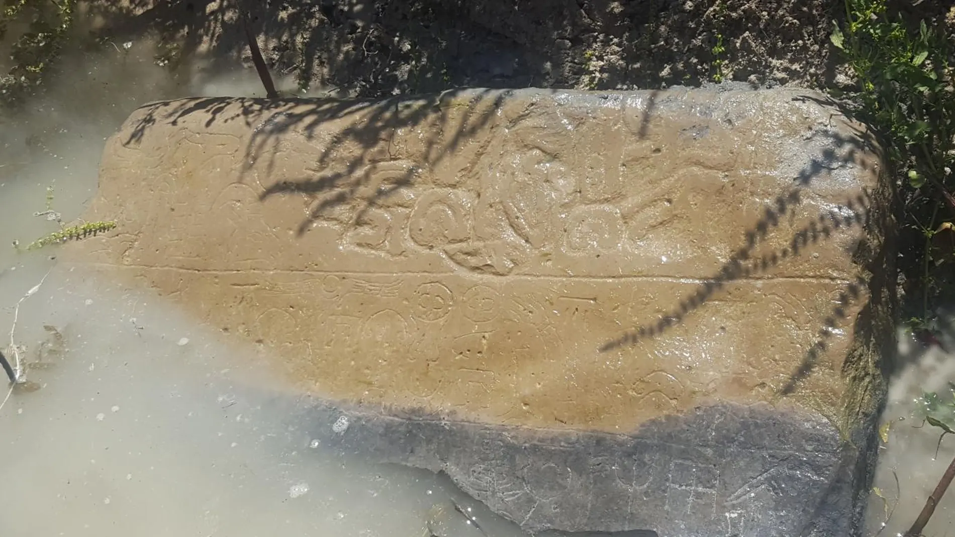 Un consejo de un agricultor turco local llevó a los arqueólogos a esta piedra medio sumergida en un canal de riego. Las inscripciones del siglo VIII a. C. todavía son visibles.