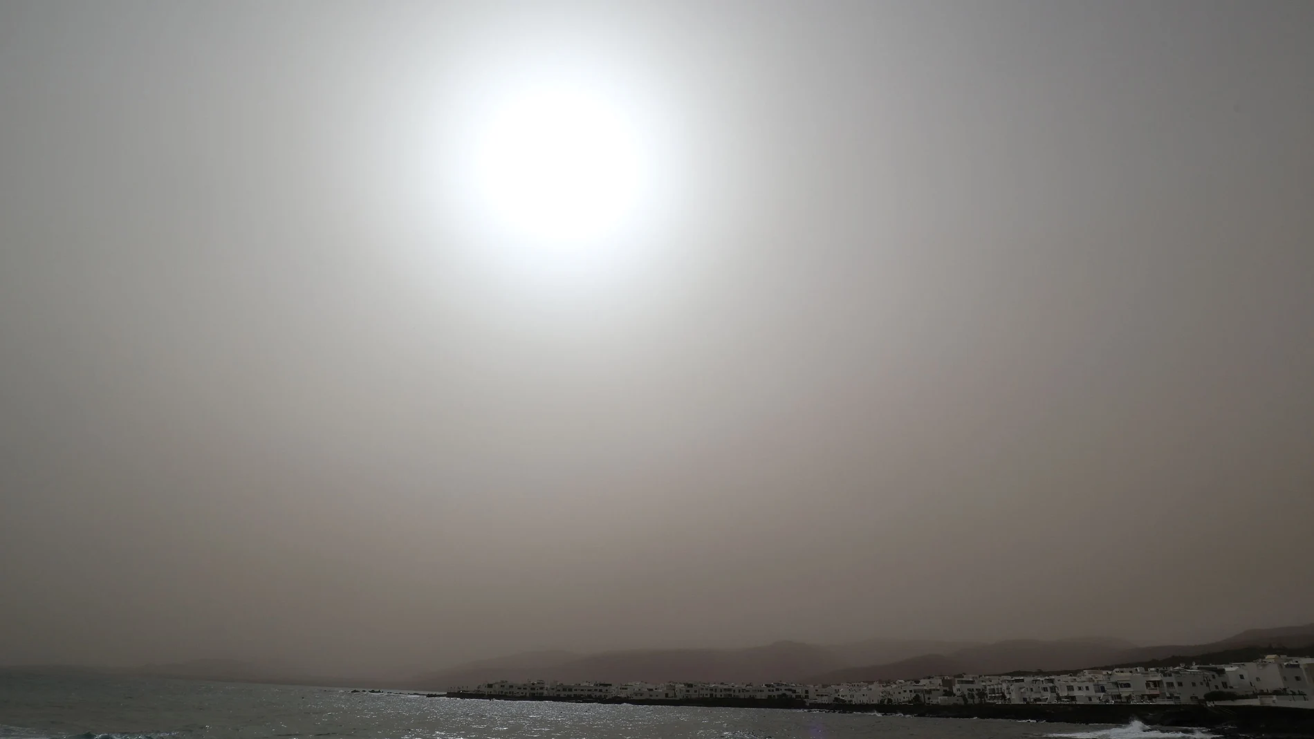 A hazy sun is seen through a sand storm known locally as the La Calima, off the coast of Punta Mjueres, Lanzarote