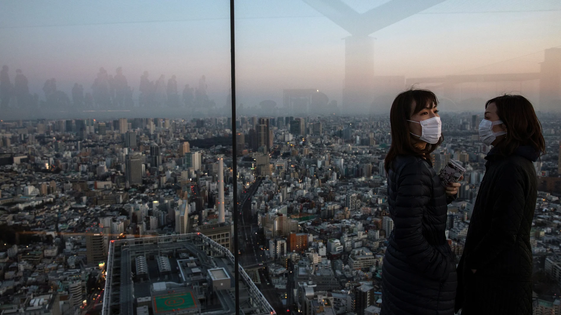People wearing protective masks are seen at the Shibuya sky observation deck, following an outbreak of the novel coronavirus in Tokyo
