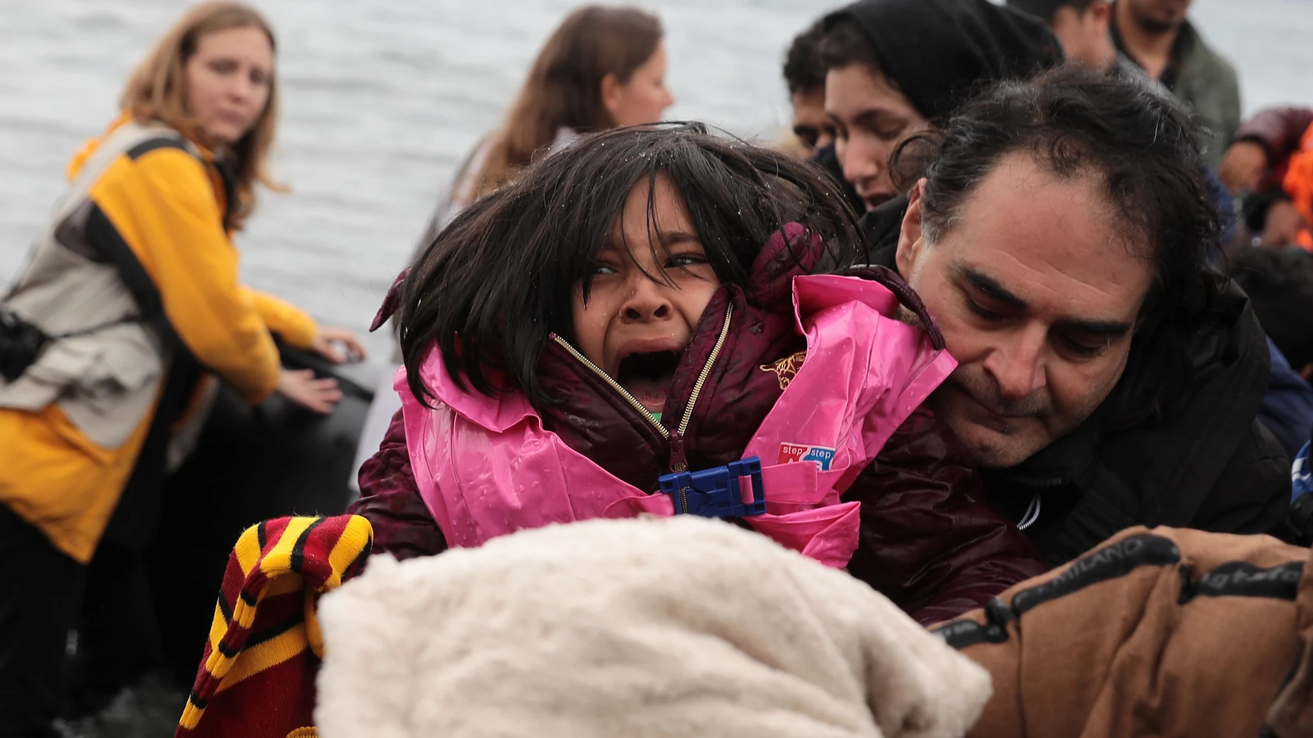 A girl reacts as migrants from Afghanistan arrive on a dinghy on a beach near the village of Skala Sikamias on the island of Lesbos, Greece, February 28, 2020. REUTERS/Costas Baltas