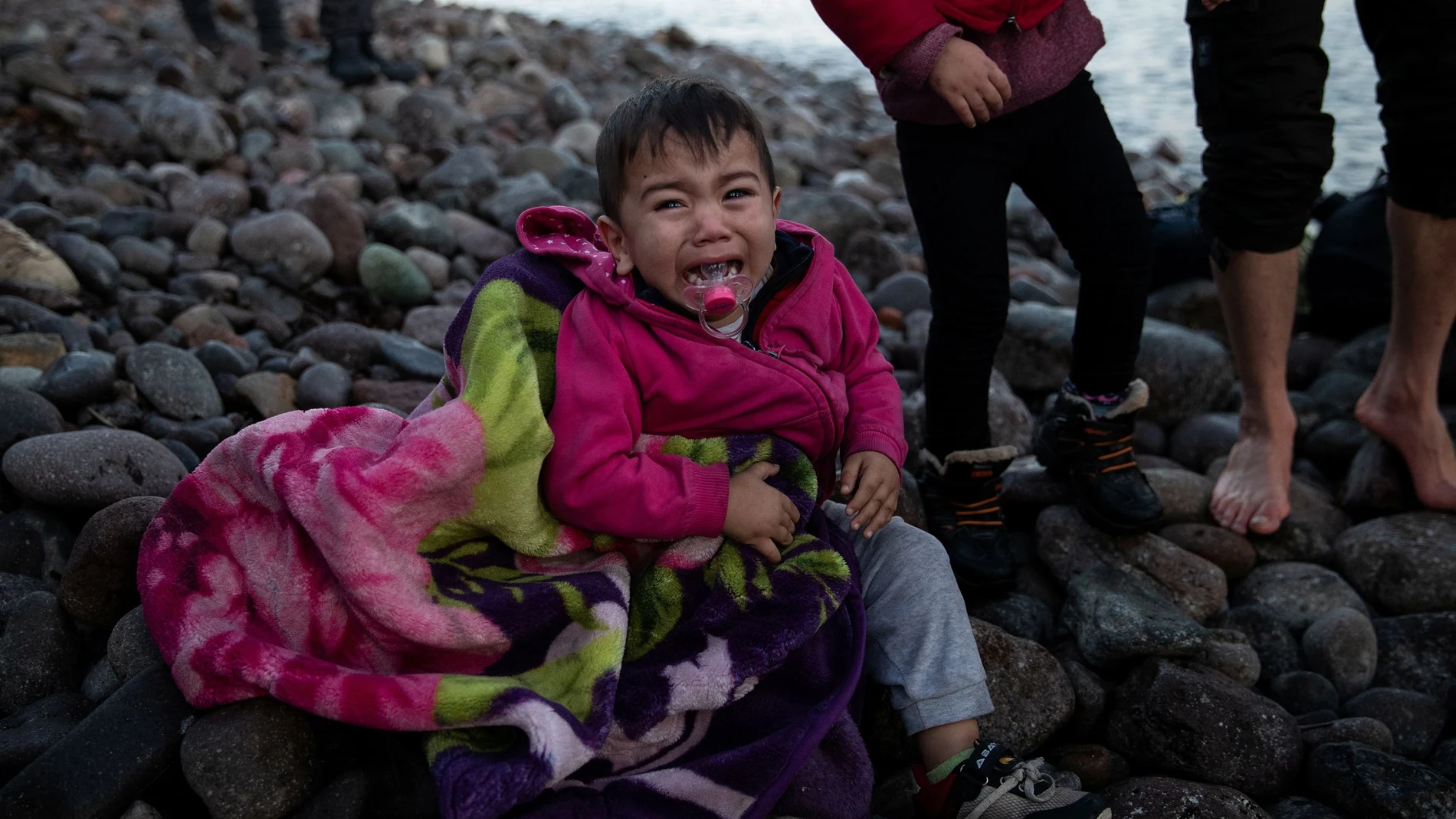 A child cries as migrants from Afghanistan arrive on a dinghy on a beach near the village of Skala Sikamias, after crossing part of the Aegean Sea from Turkey to the island of Lesbos