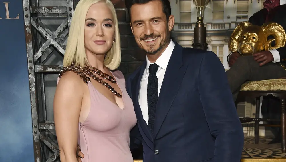 FILE - This Aug. 21, 2019 file photo shows Orlando Bloom, right, a cast member in the Amazon Prime Video series "Carnival Row," with singer Katy Perry, at the premiere of the series in Los Angeles. Perry has revealed she's pregnant at the end of the video for her latest song “Never Worn White.†The news was confirmed Thursday by Perry's label, Capitol Music Group. The baby will be Perry's first, and the second for her fiance, Orlando Bloom, who has a 9-year-old son, Flynn, with ex-wife Miranda Kerr. (Photo by Chris Pizzello/Invision/AP, File)