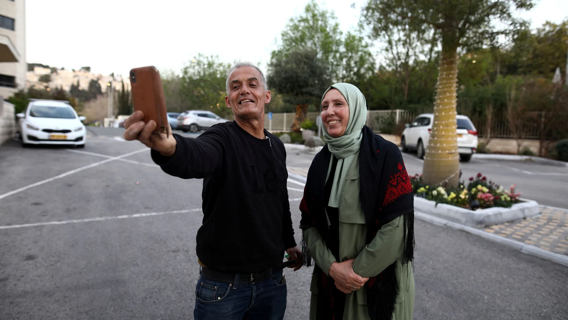 Iman Yassin Khatib, poised to become the first lawmaker in Israel's history to wear a hijab or head scarf, which she does as a Muslim, following results of her Arab Joint List party in Israel's election, takes a selfie with a friend in Nazareth