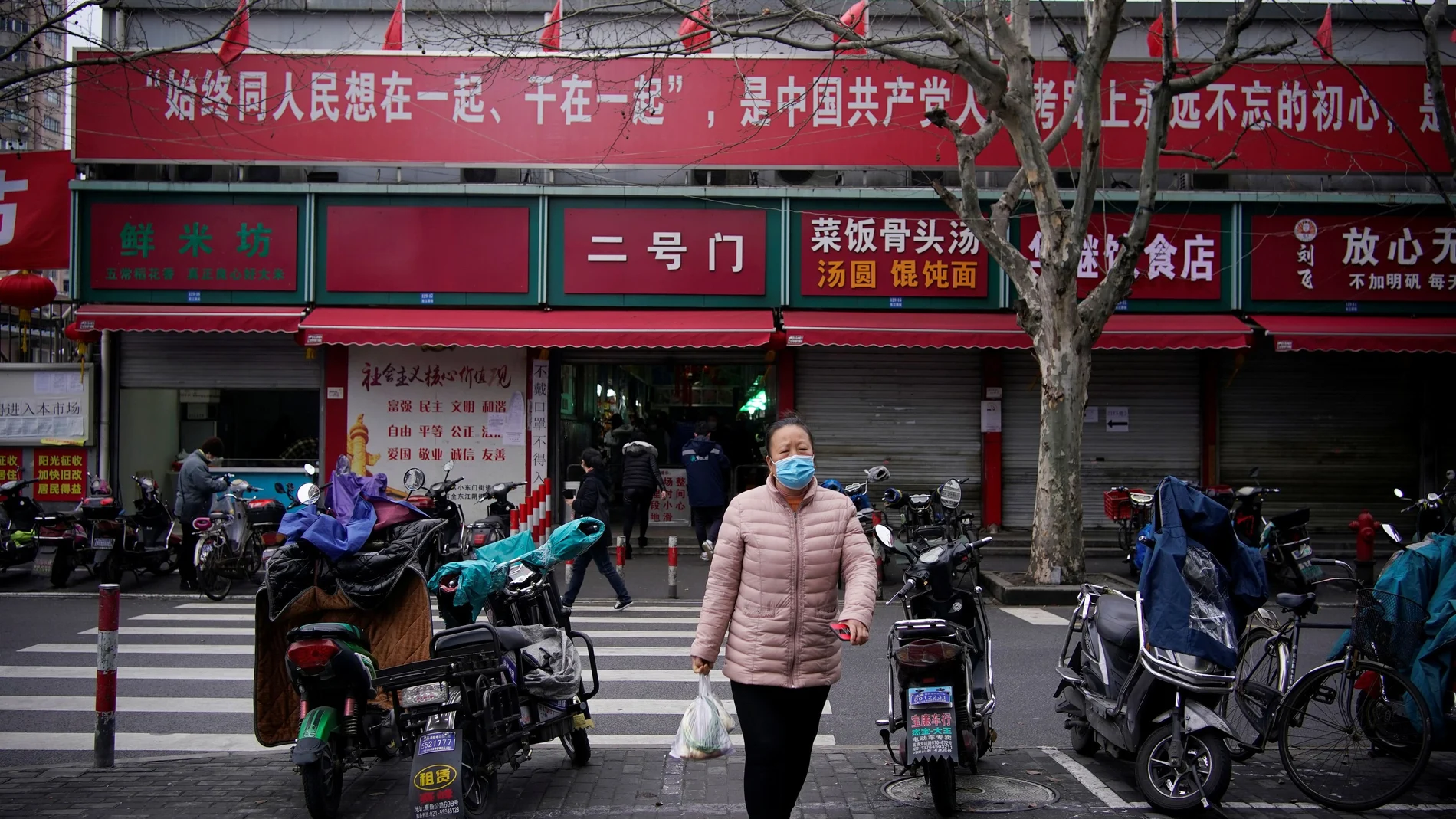 A woman wearing a protective face mask is seen at a residential community following an outbreak of coronavirus (COVID-19), in downtown Shanghai