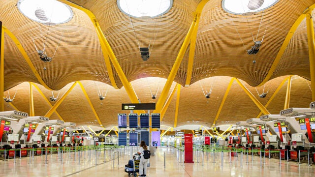 Una turista observa hace unas semanas los paneles de la Terminal 4 del Aeropuerto Adolfo Suárez-Madrid Barajas sin apenas vuelos