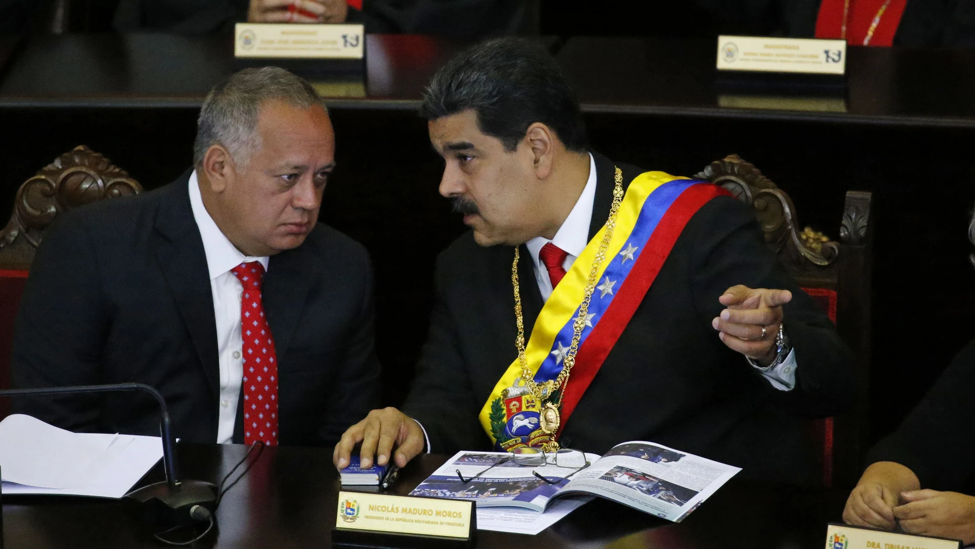 FILE - In this Jan. 24, 2019 file photo, Venezuelan President Nicolas Maduro, right, speaks with Constitutional Assembly President Diosdado Cabello at the Supreme Court during an annual ceremony that marks the start of the judicial year in Caracas, Venezuela. On Thursday, March 26, 2020, the U.S. Justice Department made public it has charged in several indictments against Maduro and his inner circle, including Cabello, that the leader has effectively converted Venezuela into a criminal enterprise at the service of drug traffickers and terrorist groups as he and his allies stole billions from the South American country. (AP Photo/Ariana Cubillos, File)