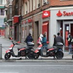 Varias personas esperan para entrar a una oficina del Banco Santander