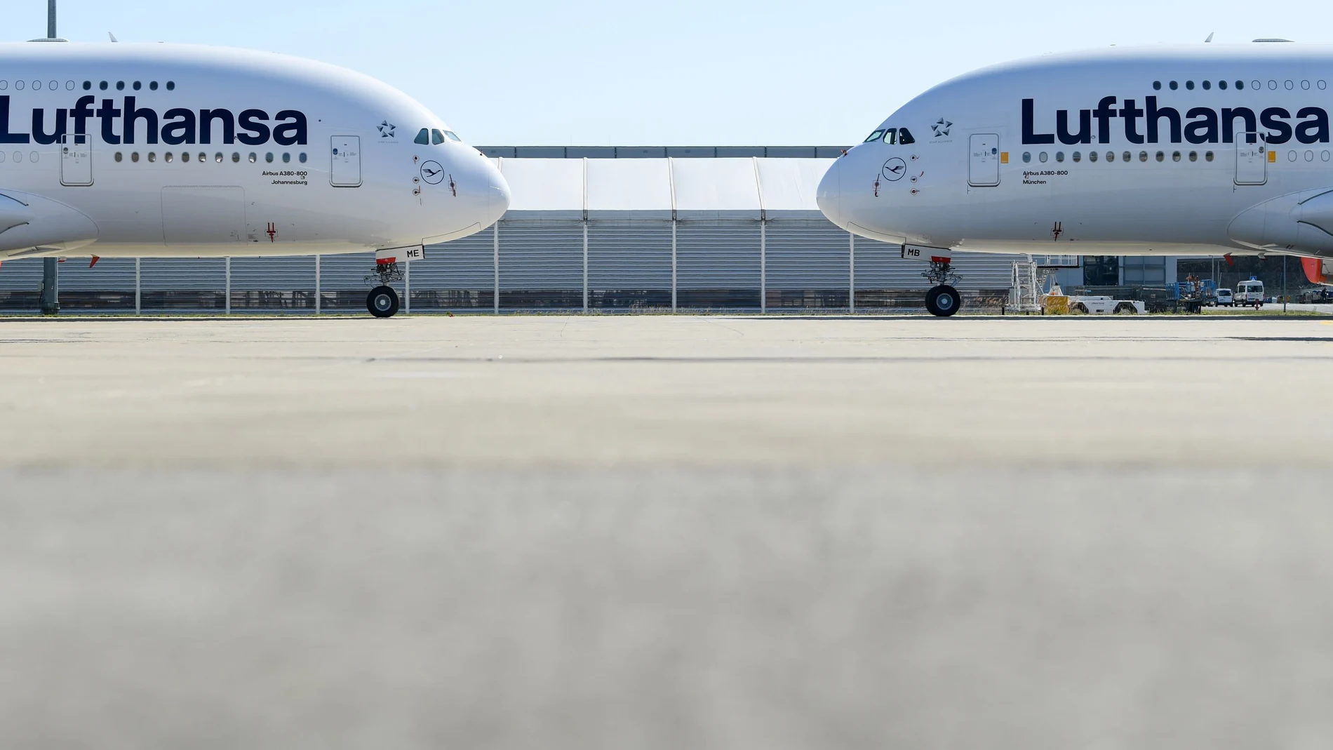 FILE PHOTO: Two Lufthansa planes parked as air traffic is affected by the coronavirus, in Frankfurt, Germany