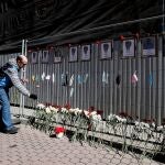 Un hombre deposita flores como homenaje a los sanitarios fallecidos a causa del coronavirus en un memorial improvisado frente a un hospital del centro de San Petersburgo.