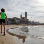 Una persona hace ejercicio en la playa de Sitges