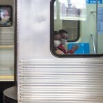 04 May 2020, Brazil, Sao Paulo: Two women sit in a train while wearing face masks to reduce the risk of infection by the coronavirus (Covid-19). Photo: Paulo Lopes/ZUMA Wire/dpa04/05/2020 ONLY FOR USE IN SPAIN
