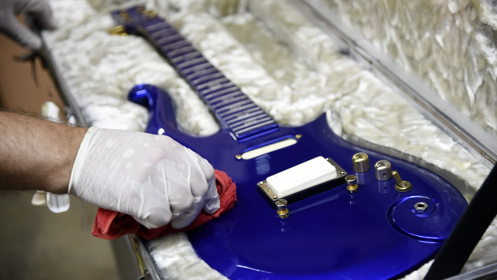 A blue "cloud" guitar custom-made in the 1980s for the late musician Prince is polished at Julien's Auctions warehouse, Wednesday, May 6, 2020, in Culver City, Calif. Julien's Auctions announced Monday that the guitar will be part of a major music artifacts auction taking place on June 19 and 20 in Beverly Hills and online. (AP Photo/Chris Pizzello)
