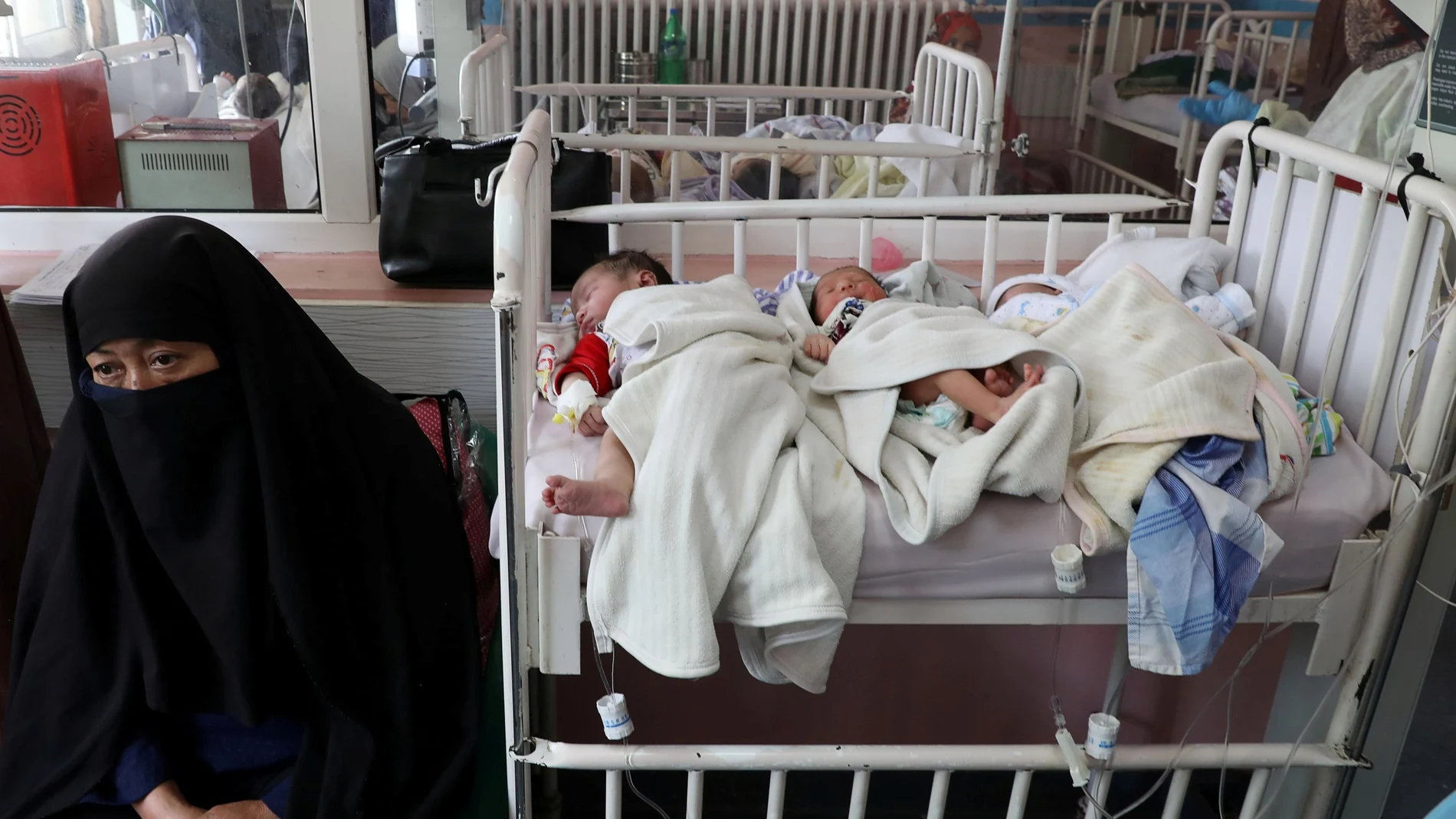 Newborn children who lost their mothers during the yesterday's attack lie on a bed at a hospital, in Kabul