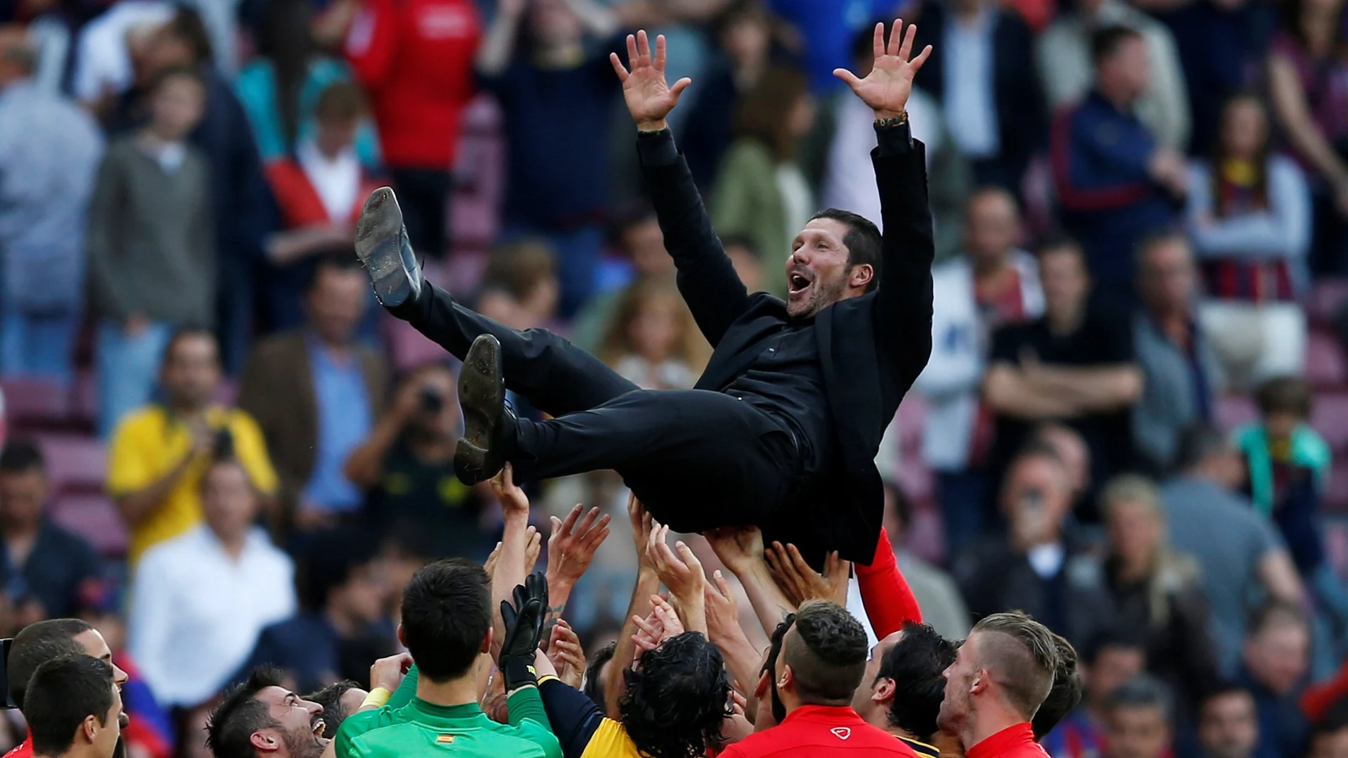 FILE PHOTO: Atletico Madrid coach Diego Simeone celebrates with players after winning the Spanish La Liga title following their 1-1 draw against Barcelona at Camp Nou stadium.