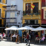 Varias personas disfrutan en una terraza de un bar después de que el Ministerio de Sanidad autorizara a que la totalidad de la Comunidad Valenciana pasase en su conjunto a la fase 1 de la desescalada. Las terrazas de los restaurantes y bares de Valencia podrán bajarse a las calzadas con la entrada de la ciudad en la fase 1 de la desescalad