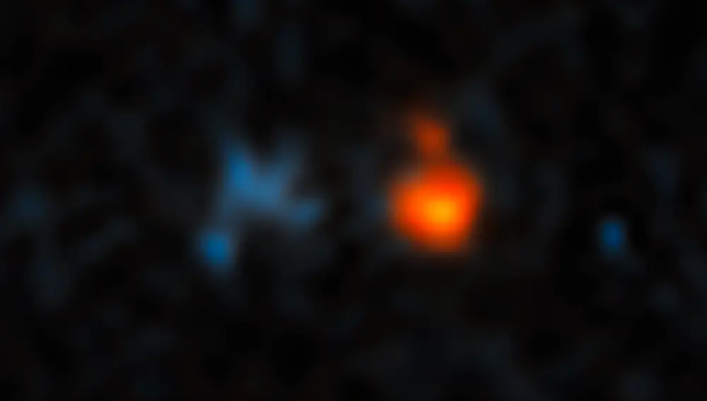 Imagen del cuásar J043947.08+163415.7, uno de los más brillantes del universo temprano. La luz de este objeto nos llega desde una distancia de 12.800 millones de años luz, y se origina en una galaxia recién nacida que está formando miles de nuevas estrellas al mismo tiempo, empujada por el “viento” que emite un enorme agujero negro en su centro. Los cuásares son los objetos más lejanos que podemos observar, gracias a su deslumbrante brillo.