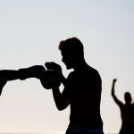 Varias personas practican deporte en la playa del Somrrostro de Barcelona