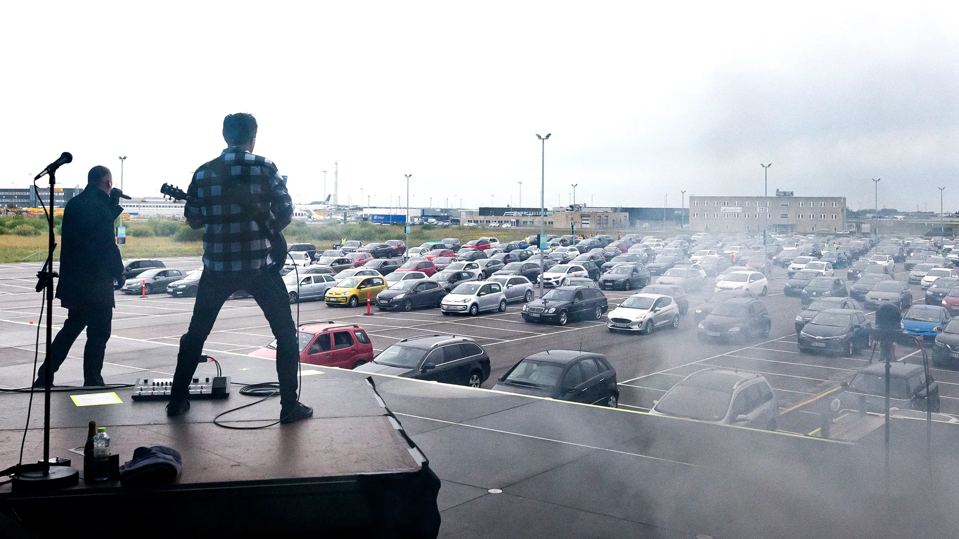 Liam O'Connor on stage in the parking lot of Copenhagen airport.