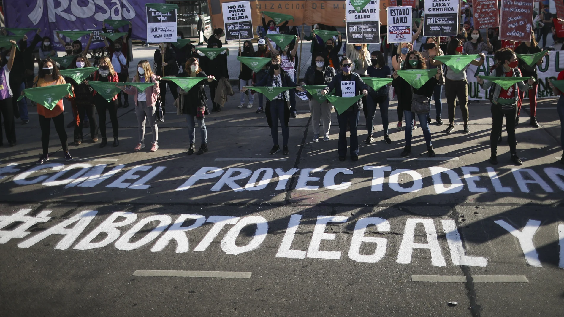 Pro-choice activists hold the iconic green handkerchiefs in favor of decriminalizing abortion as they protest outside Congress during a government-ordered lockdown to curb the spread of the coronavirus in Buenos Aires, Argentina, Thursday, May 28, 2020. (AP Photo/Natacha Pisarenko)