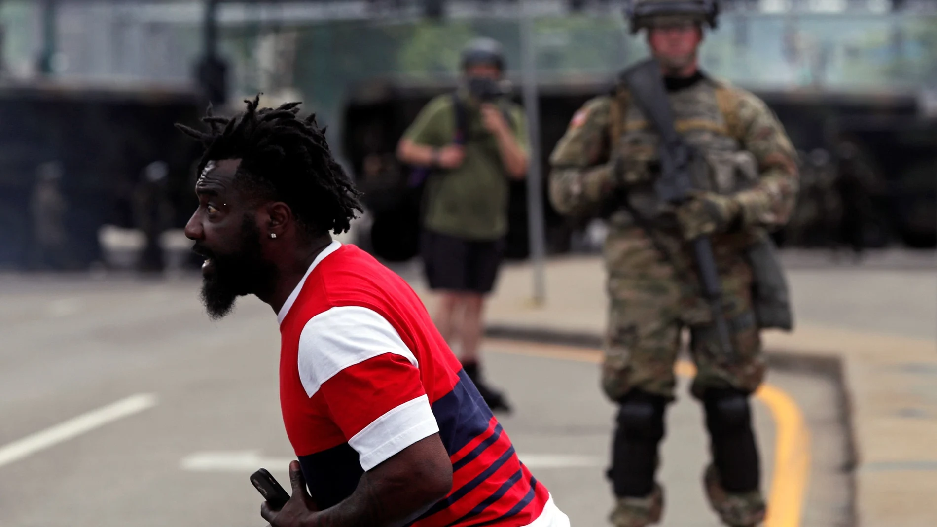 Man reacts as he confronts National Guard members guarding the area in the aftermath of a protest, in Minneapolis
