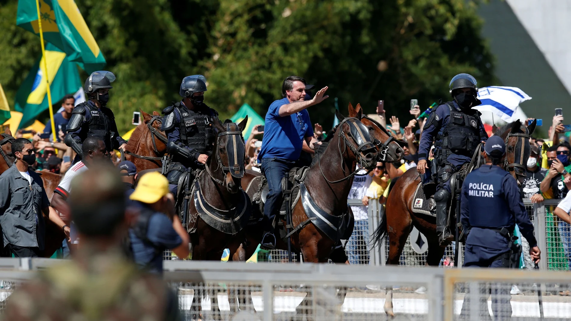 Brazil's President Jair Bolsonaro rides a horse during a meeting with supporters protesting in his favor, amid the coronavirus disease (COVID-19) outbreak, in Brasilia