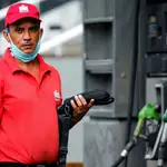 A worker of a gas station looks on, after Venezuela&#39;s government launched new fuel pricing system, in Caracas, Venezuela June 1, 2020. REUTERS/Manaure Quintero