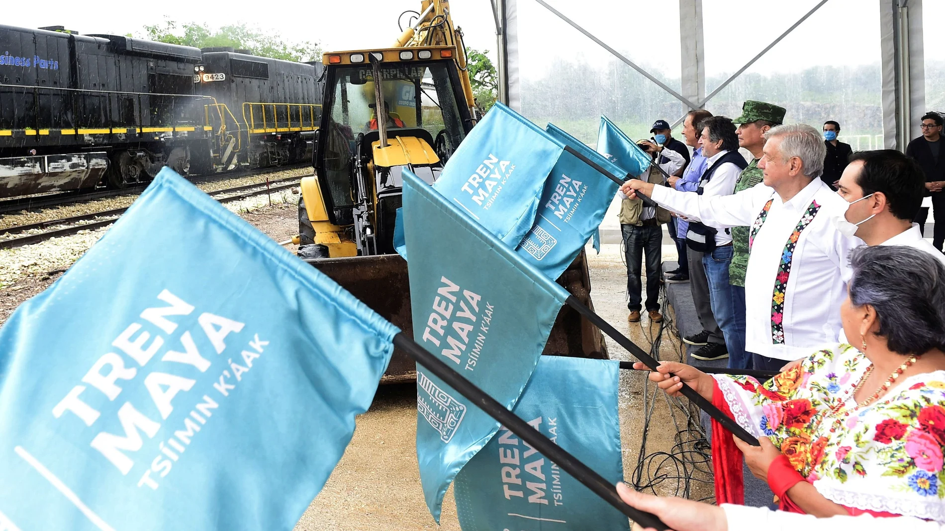 Mexico's President Andres Manuel Lopez Obrador waves a flag during the start of the third section of the construction of the Mayan Train railroad project, in Maxcanu