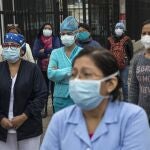Nurses and doctors chant slogans as they protest the lack of protective equipment for health workers attending COVID-19 patients, outside a public hospital in Lima, Peru, Tuesday, June, 2, 2020. (AP Photo/Rodrigo Abd)