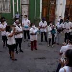 Doctor Xiomara Acosta (C) gives orientations to medical students before checking door-to-door for people with symptoms amid concerns about the spread of the coronavirus disease (COVID-19), in downtown Havana, Cuba, May 12, 2020. Picture taken May 12, 2020. REUTERS/Alexandre Meneghini