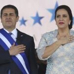 FILE - In this Jan. 27, 2018 file photo, Honduran President Juan Orlando Hernandez, left, stands with his wife Ana Garcia, during the presidential inauguration ceremony for his second term at the National Stadium in Tegucigalpa, Honduras. HernÃ¡ndez and his wife have tested positive for COVID-19, the Central American leader said late Tuesday, June 16, 2020, in a television message. (AP Photo/Fernando Antonio, File)