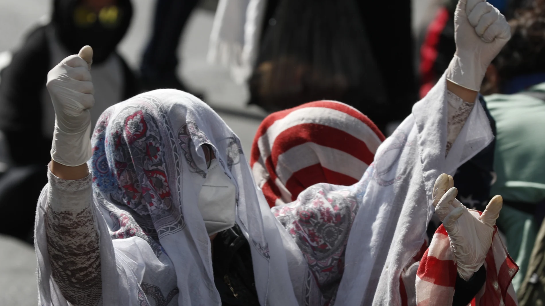 A sex worker wears a mask amid the new coronavirus pandemic during a protest asking the government to lift restrictions on their work, in La Paz, Bolivia, Wednesday, June 17, 2020. (AP Photo/Juan Karita)