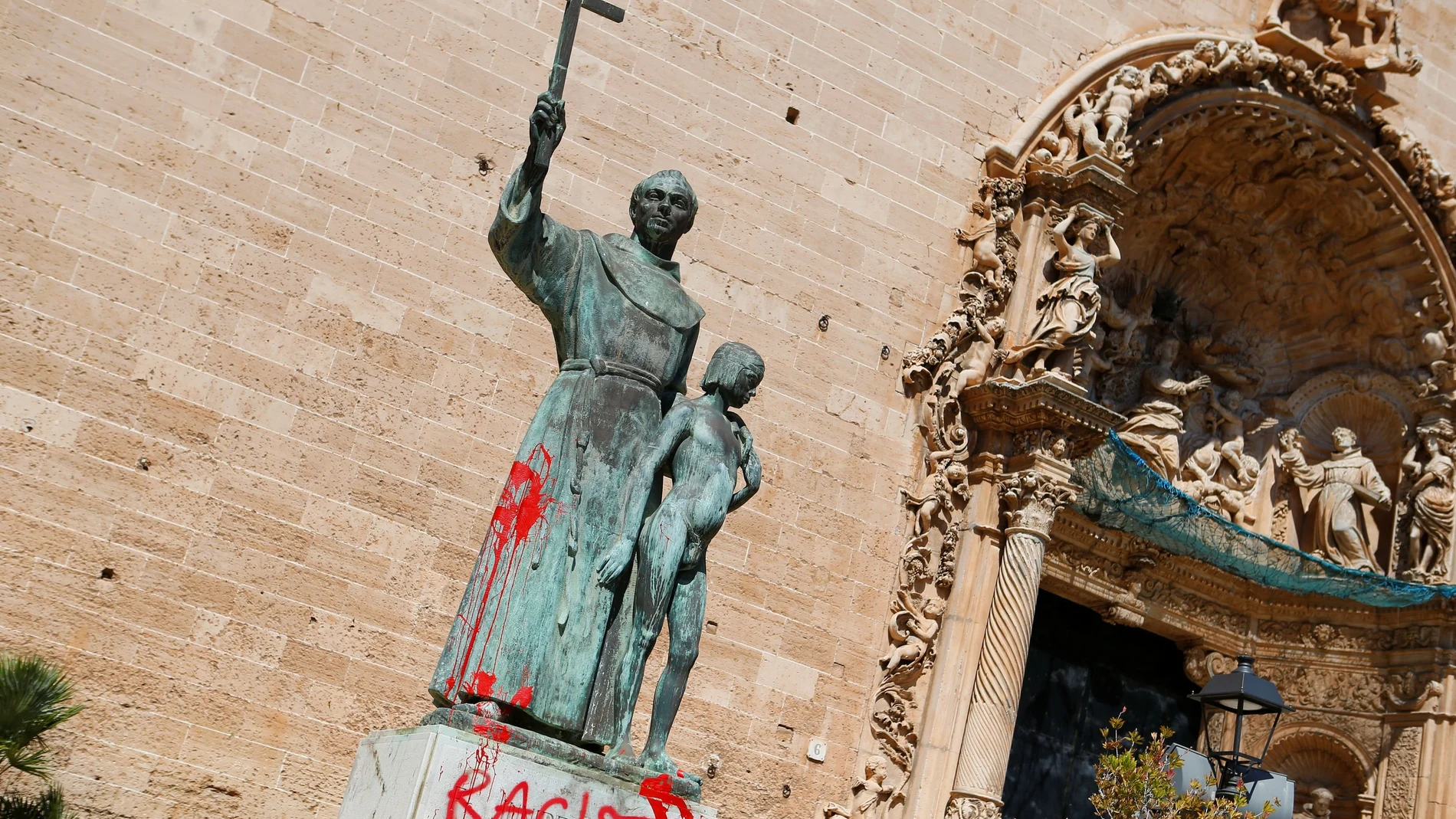 A graffiti reading "racist" is seen on a statue of Fray Junipero Serra in Palma de Mallorca