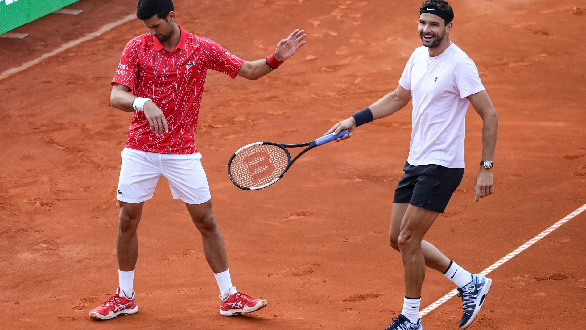 Serbia's Novak Djokovic with Bulgaria's Grigor Dimitrov during their doubles match during Adria Tour at Novak Tennis Centre in Belgrade