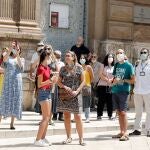 Un grupo de turistas de vista en las cercanías de la Catedral de Valencia que empieza a recuperar la normalidad tras el estado de alarma