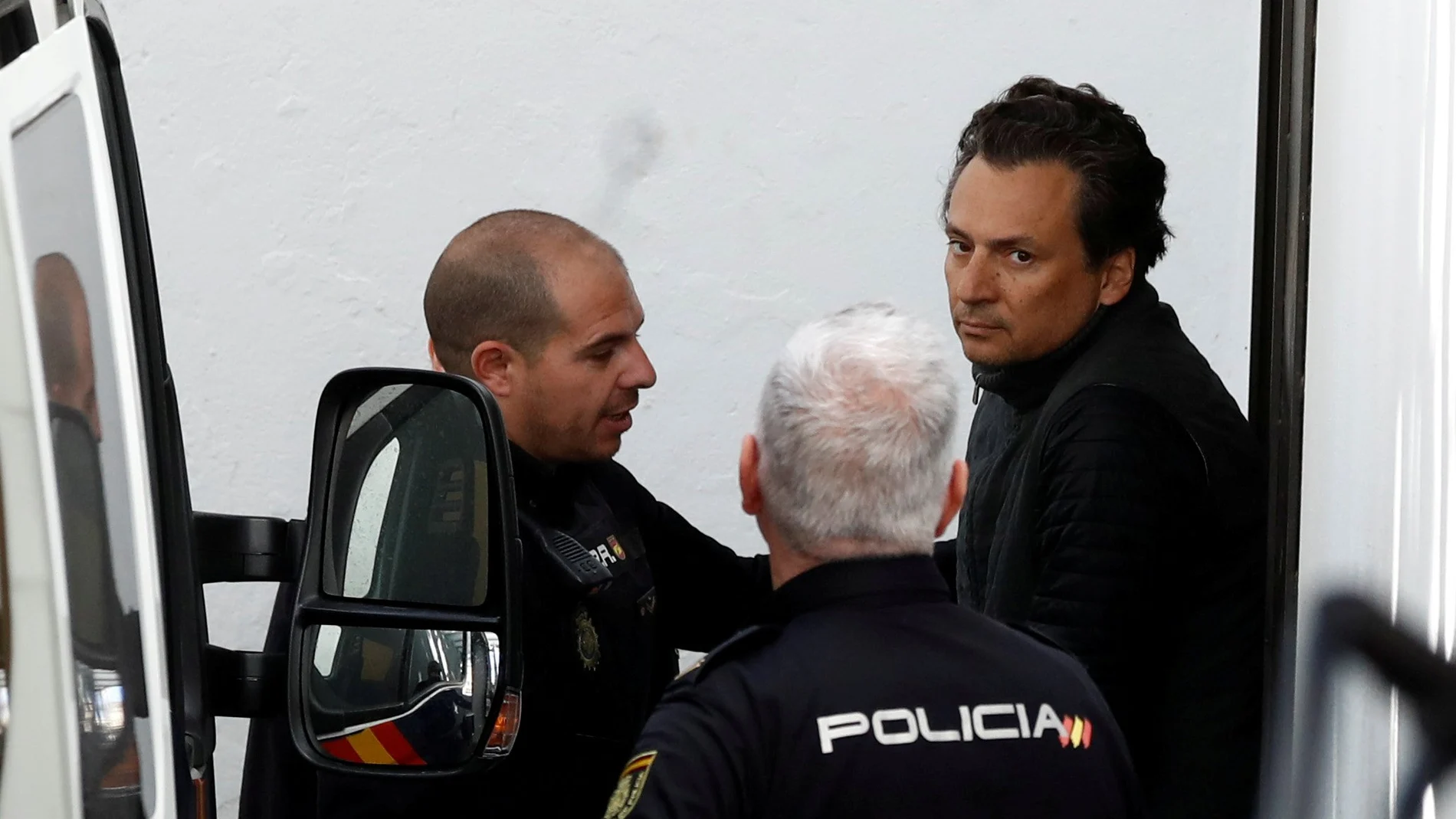 FILE PHOTO: Former chief executive of Mexico's state oil firm Pemex, Emilio Lozoya, is escorted by Spanish police officers as he leaves a court after appeared in Spain's High Court via video conference, after his detention in southern Spain on Wednesday,